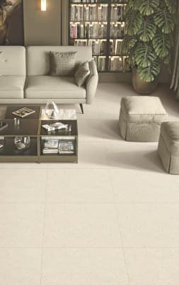 A living room with a cream Sandy series tile floor