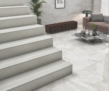 A staircase finished in light grey full body step and riser tiles