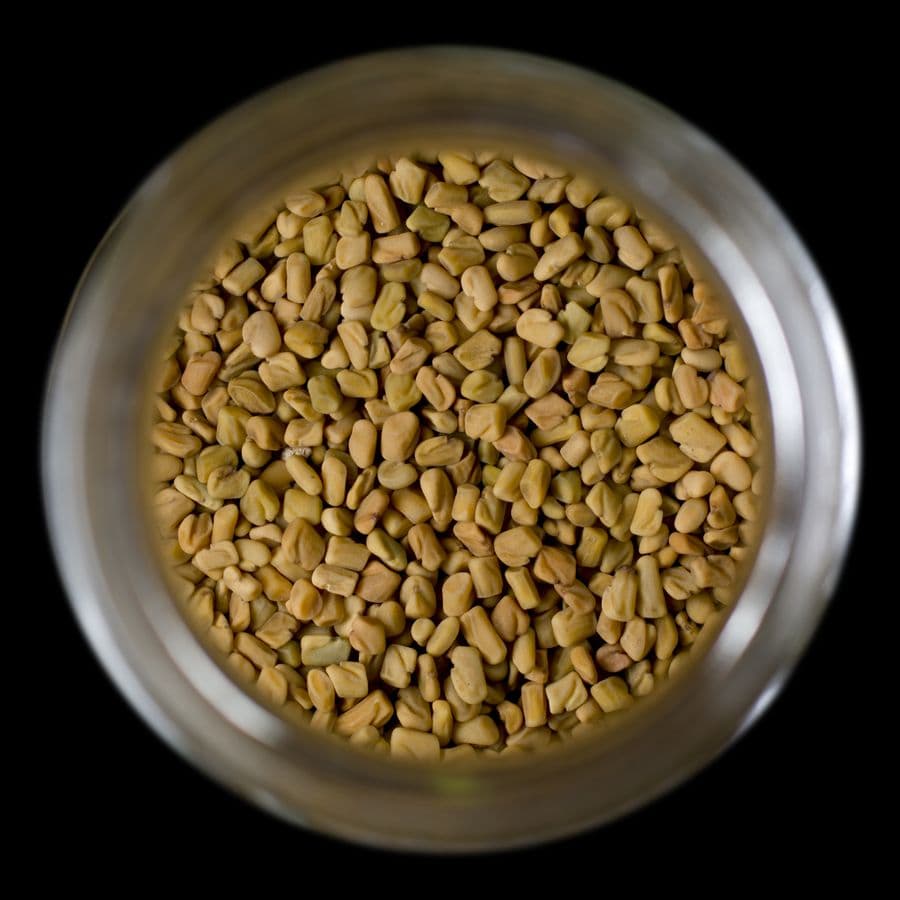 Fenugreek seeds in a glass jar seen from above