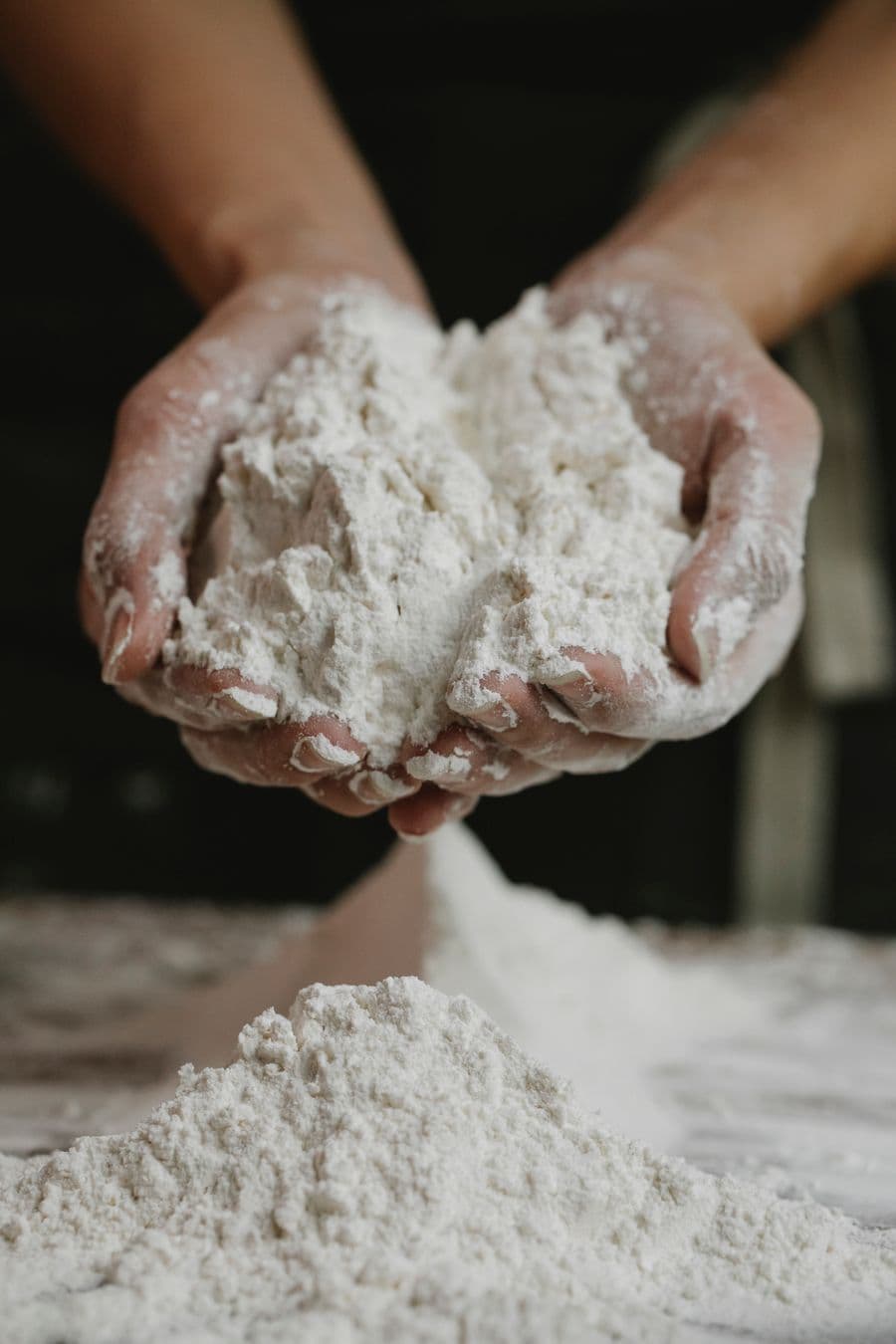 Hands holding a handful of fine flour